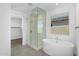 Luxurious bathroom featuring a glass shower, soaking tub, and modern fixtures at 4811 W Hunter Trl, San Tan Valley, AZ 85144