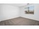 Minimal bedroom with carpet, white walls, and a window at 4811 W Hunter Trl, San Tan Valley, AZ 85144