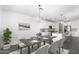 Elegant dining room connected to the kitchen, featuring modern decor, and pendant lighting over the table at 4811 W Hunter Trl, San Tan Valley, AZ 85144