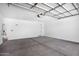 Spacious garage featuring concrete flooring, door to the backyard, and water heater at 4811 W Hunter Trl, San Tan Valley, AZ 85144