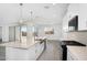 Modern kitchen with a large island, stainless steel sink, and access to the backyard at 4811 W Hunter Trl, San Tan Valley, AZ 85144