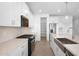 Well-appointed kitchen featuring stainless steel appliances, pantry, and quartz countertops at 4811 W Hunter Trl, San Tan Valley, AZ 85144