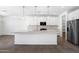 Spacious kitchen with a large island, pendant lighting, and stainless steel refrigerator at 4811 W Hunter Trl, San Tan Valley, AZ 85144