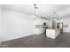 Bright kitchen featuring white cabinets, stainless steel appliances, granite countertops, and pendant lighting at 4811 W Hunter Trl, San Tan Valley, AZ 85144