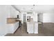 Bright, open kitchen featuring white cabinets, stainless steel appliances, and a large island at 4811 W Hunter Trl, San Tan Valley, AZ 85144