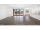 Open-concept living space with tiled floors, mountain views through large sliding doors, and a modern kitchen at 4811 W Hunter Trl, San Tan Valley, AZ 85144