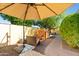 Inviting backyard with a patio area, playhouse, mature trees, and ample space to relax at 502 W Windsor Ave, Phoenix, AZ 85003