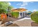 Spacious backyard featuring a patio area, lush greenery, and a charming playhouse, perfect for outdoor enjoyment at 502 W Windsor Ave, Phoenix, AZ 85003