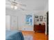 Bright bedroom with hardwood floors, a ceiling fan, and a window with white shutters at 502 W Windsor Ave, Phoenix, AZ 85003