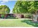 Charming brick home with a lush green lawn, mature trees, and well-maintained landscaping at 502 W Windsor Ave, Phoenix, AZ 85003