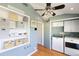 Bright laundry room with washer, dryer, built-in shelves and ceiling fan at 502 W Windsor Ave, Phoenix, AZ 85003