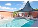 Beautiful backyard pool area with lounge chairs and a shade structure, perfect for outdoor relaxation and entertaining at 502 W Windsor Ave, Phoenix, AZ 85003