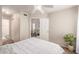 Bright bedroom featuring a ceiling fan, plant accent, and doorway to the living room at 5136 E Evergreen St # 1142, Mesa, AZ 85205