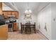 Inviting dining area featuring a chandelier, a mirror, and easy access to the kitchen at 5136 E Evergreen St # 1142, Mesa, AZ 85205