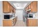 Efficient kitchen featuring ample cabinet space, modern appliances, and a skylight for natural lighting at 5136 E Evergreen St # 1142, Mesa, AZ 85205