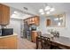 Well-lit kitchen with wooden cabinets, stainless steel appliances, and adjacent dining area at 5136 E Evergreen St # 1142, Mesa, AZ 85205