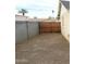Backyard showing the side of the house with gravel and wood privacy gate at 5435 W Christy Dr, Glendale, AZ 85304
