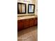 Bright bathroom featuring dual sinks with granite countertops and tiled floors at 5435 W Christy Dr, Glendale, AZ 85304