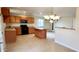 Open kitchen featuring wood cabinets, a center island, and tile flooring at 5435 W Christy Dr, Glendale, AZ 85304