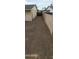 View of long side yard with gravel, fenced, offering privacy and low maintenance landscaping solutions at 5435 W Christy Dr, Glendale, AZ 85304