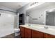 Well-lit bathroom features double sink vanity, toilet and shower/tub combo at 5440 W Apollo Rd, Laveen, AZ 85339