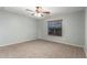 Inviting bedroom boasting plush carpeting, a ceiling fan, and a window with blinds for privacy and light control at 5440 W Apollo Rd, Laveen, AZ 85339