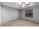 Neutral bedroom featuring ceiling fan, window with blinds and neutral walls and carpet at 5440 W Apollo Rd, Laveen, AZ 85339