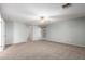 This spacious bedroom with a ceiling fan and plush carpeting provides a relaxing retreat, while the open doorway enhances its airiness at 5440 W Apollo Rd, Laveen, AZ 85339