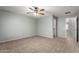 Bedroom featuring plush carpeting, a ceiling fan, and neutral paint, creating a serene and inviting atmosphere at 5440 W Apollo Rd, Laveen, AZ 85339