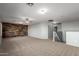 Expansive bonus room with wood accent wall, carpet flooring, and ample natural light at 5440 W Apollo Rd, Laveen, AZ 85339