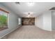 Large bonus room featuring a wooden accent wall, plush carpeting, and natural light from the window at 5440 W Apollo Rd, Laveen, AZ 85339