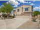 Two-story stucco home with three-car garage and desert landscaping at 5440 W Apollo Rd, Laveen, AZ 85339