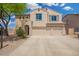 Two-story stucco home with a three car garage and desert landscaping at 5440 W Apollo Rd, Laveen, AZ 85339