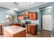 Kitchen with wood cabinets, tile floors, stainless steel appliances, and island at 5440 W Apollo Rd, Laveen, AZ 85339