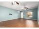 Bright living room with tiled floors, ceiling fan, and front door view at 5440 W Apollo Rd, Laveen, AZ 85339