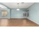 Spacious living room featuring hardwood floors, natural lighting, and a modern pendant lamp, creating a bright and inviting atmosphere at 5440 W Apollo Rd, Laveen, AZ 85339