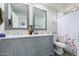 Charming bathroom with a double sink vanity, floral shower curtain, and modern fixtures at 5702 S Beck Ave, Tempe, AZ 85283