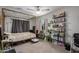 Bedroom with canopy bed frame, ceiling fan, and bookshelf filled with literature at 5702 S Beck Ave, Tempe, AZ 85283