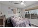 Cozy bedroom with ceiling fan, decorated walls, and a large window with neighborhood views at 5702 S Beck Ave, Tempe, AZ 85283