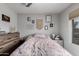 Bright bedroom features ceiling fan, and neutral walls decorated with macrame and framed prints at 5702 S Beck Ave, Tempe, AZ 85283