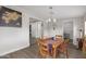 Open dining area with wood table, chandelier, and views of other rooms at 5702 S Beck Ave, Tempe, AZ 85283