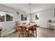 Bright dining area features wood table, wood-look floors, and a modern chandelier at 5702 S Beck Ave, Tempe, AZ 85283