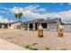 Single-story home featuring solar panels, a xeriscaped front yard, and eye-catching decor at 5702 S Beck Ave, Tempe, AZ 85283
