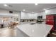 Updated kitchen with white cabinets, a large island, and seamless access to the dining area at 5702 S Beck Ave, Tempe, AZ 85283