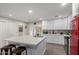 Bright kitchen with an island and white cabinets; stainless steel appliances included at 5702 S Beck Ave, Tempe, AZ 85283