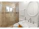 Updated bathroom with a walk-in shower, a marble countertop, and a modern sink at 5711 E Corrine Dr, Scottsdale, AZ 85254