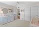 Bright bedroom with white dresser, sliding closet doors, and a ceiling fan at 5711 E Corrine Dr, Scottsdale, AZ 85254
