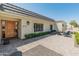 View of a single-story house with modern architectural details, manicured landscaping, and paved patio at 5711 E Corrine Dr, Scottsdale, AZ 85254