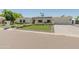 Beautiful single-story home with manicured lawn, walkway lined with white roses, and a well-maintained yard at 5711 E Corrine Dr, Scottsdale, AZ 85254
