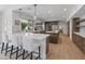 Bright kitchen featuring wooden cabinets, stainless steel appliances, and a counter with white cushioned chairs at 5711 E Corrine Dr, Scottsdale, AZ 85254